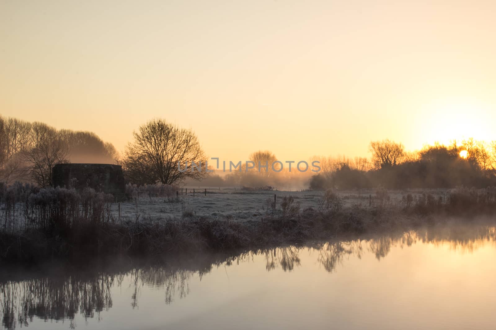 A winter cold frosty Sunrise Over the River Thames at Cheese Wharf, Oxfordshire