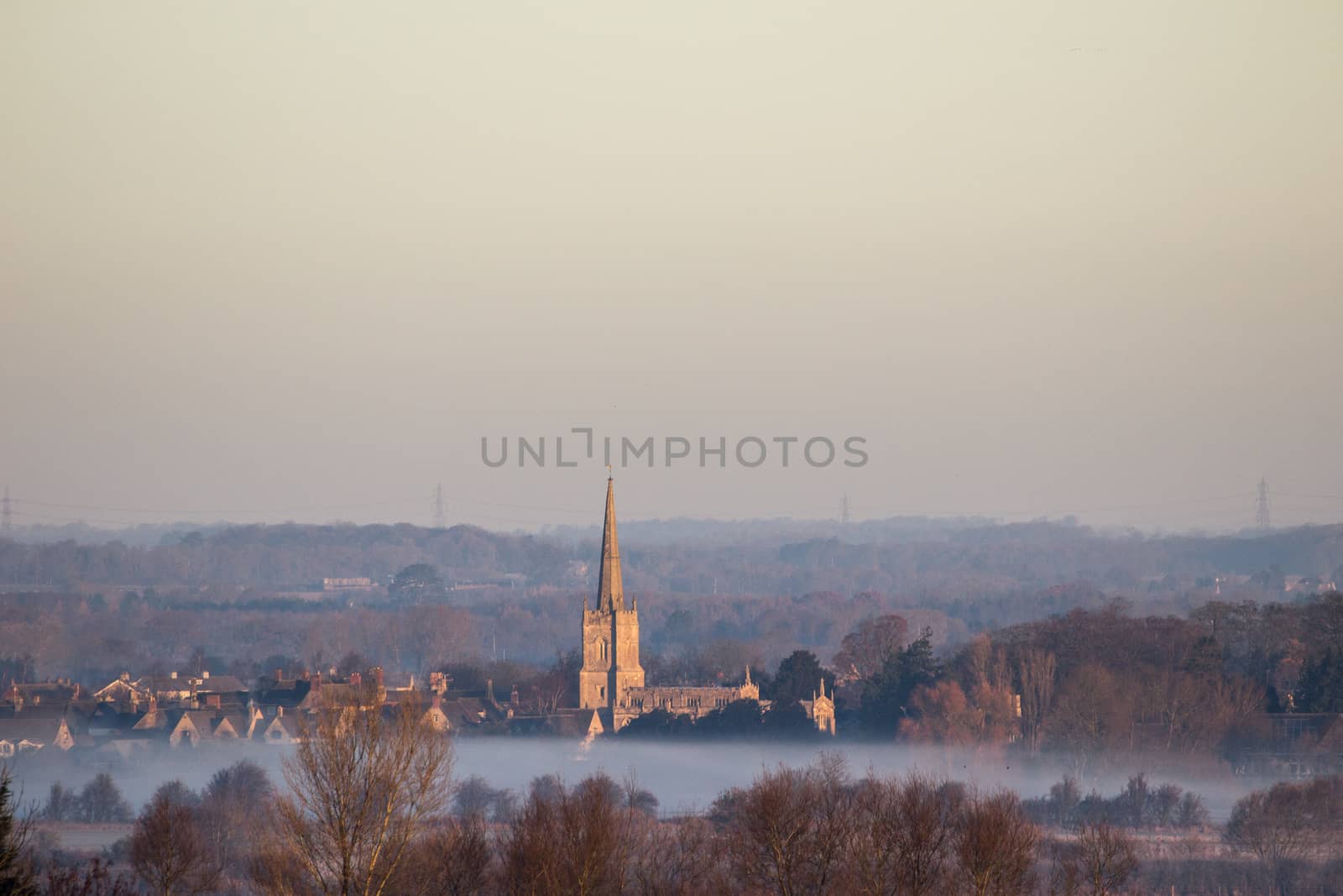 Mid Winter Foggy Sunrise over Lechlade Church in Gloucstershire, England.