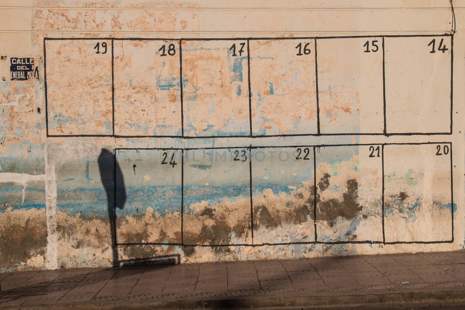 In every city in Morocco is painted on the wall a calendar of the events, which will happen in the city. This one is on an old peeled off wall in a city Sidi Ifni.