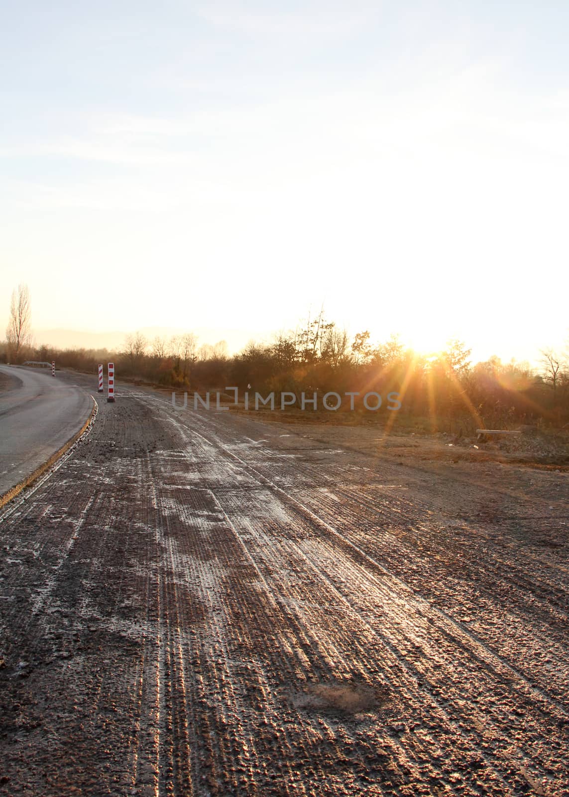 pixture of a repairing asphalt on old road on sunset