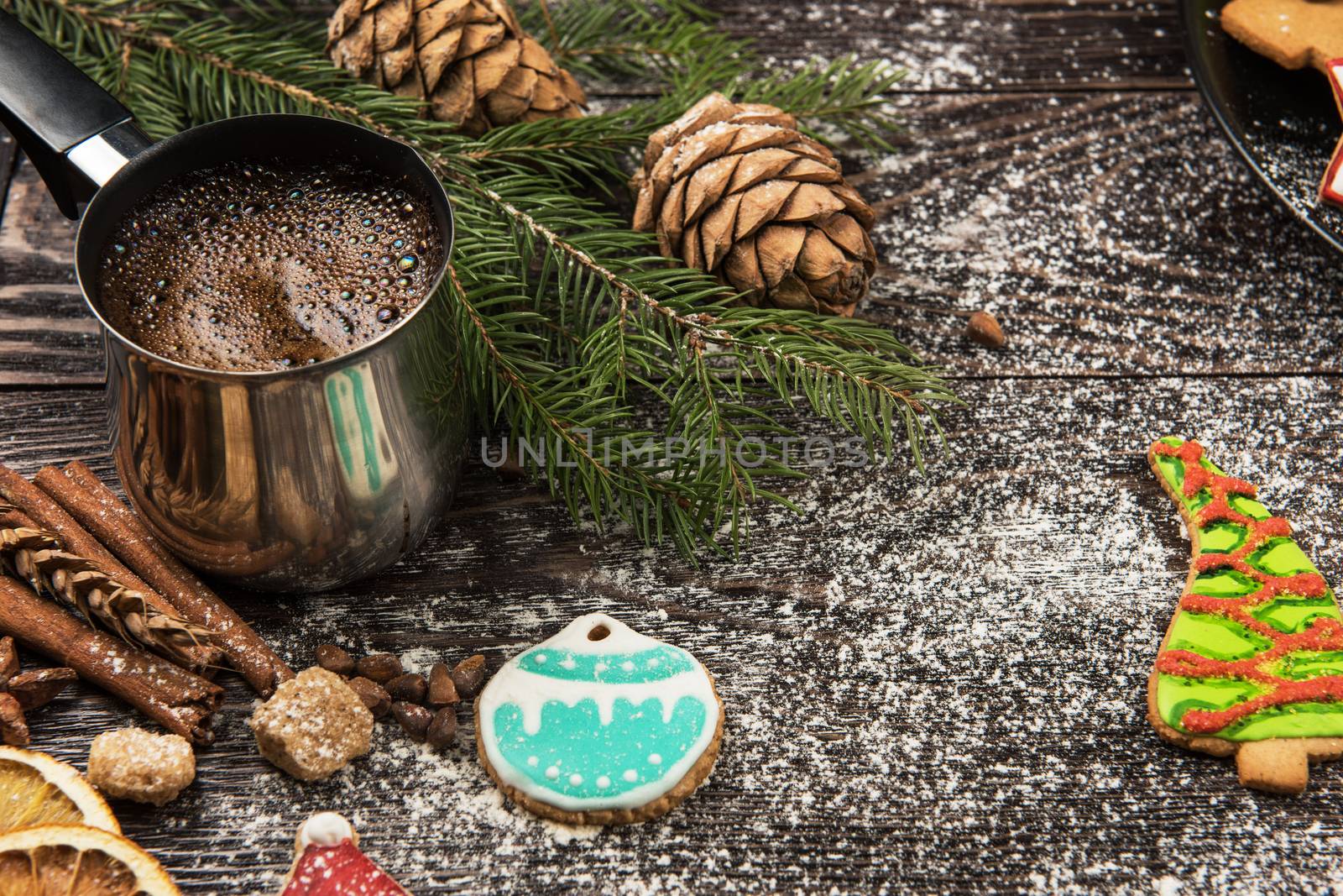 Gingerbreads and coffee for new years and christmas on wooden background, xmas theme