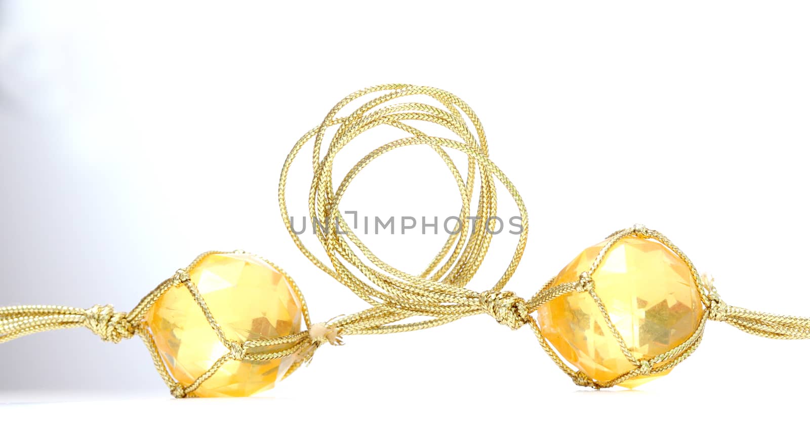 picture of a necklace with cheap plastic gems with golden colored rope
