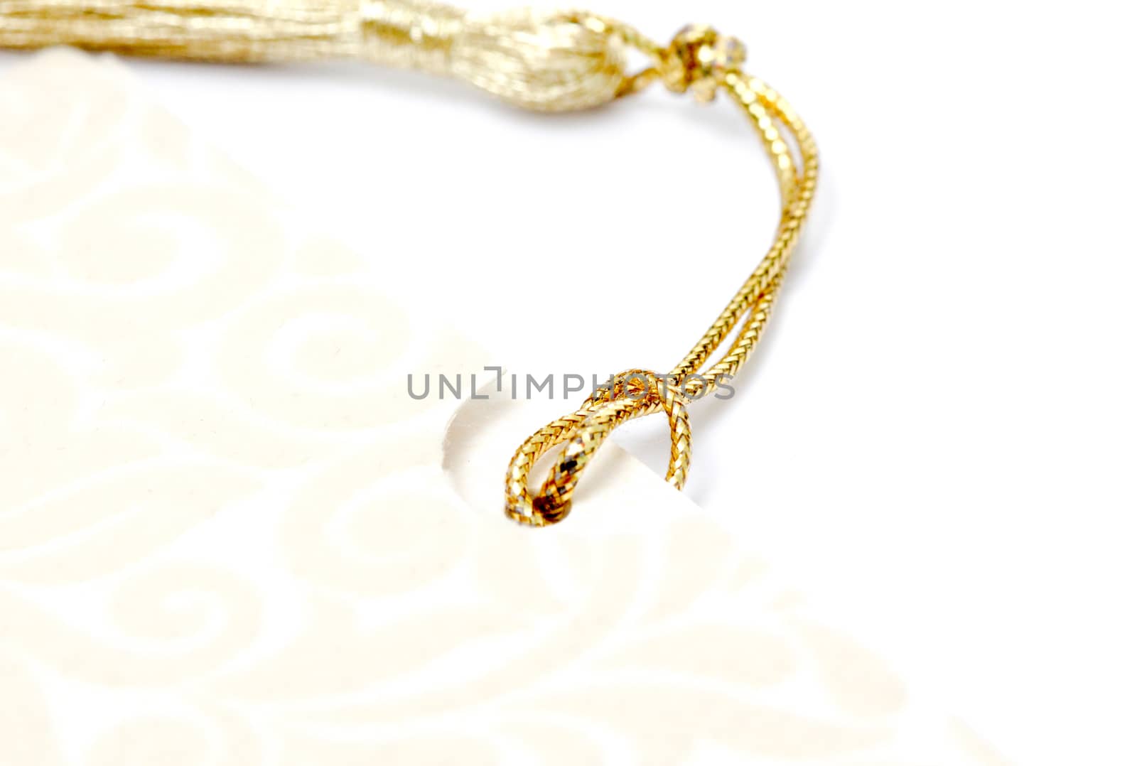 picture of a gold colored rope on white