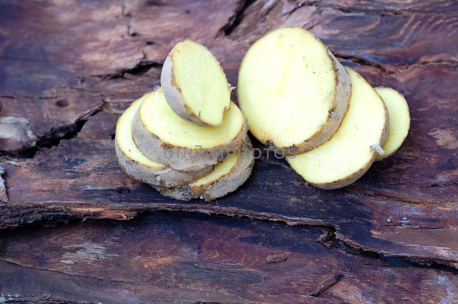 picture of a Sliced potatoes on dark wood background