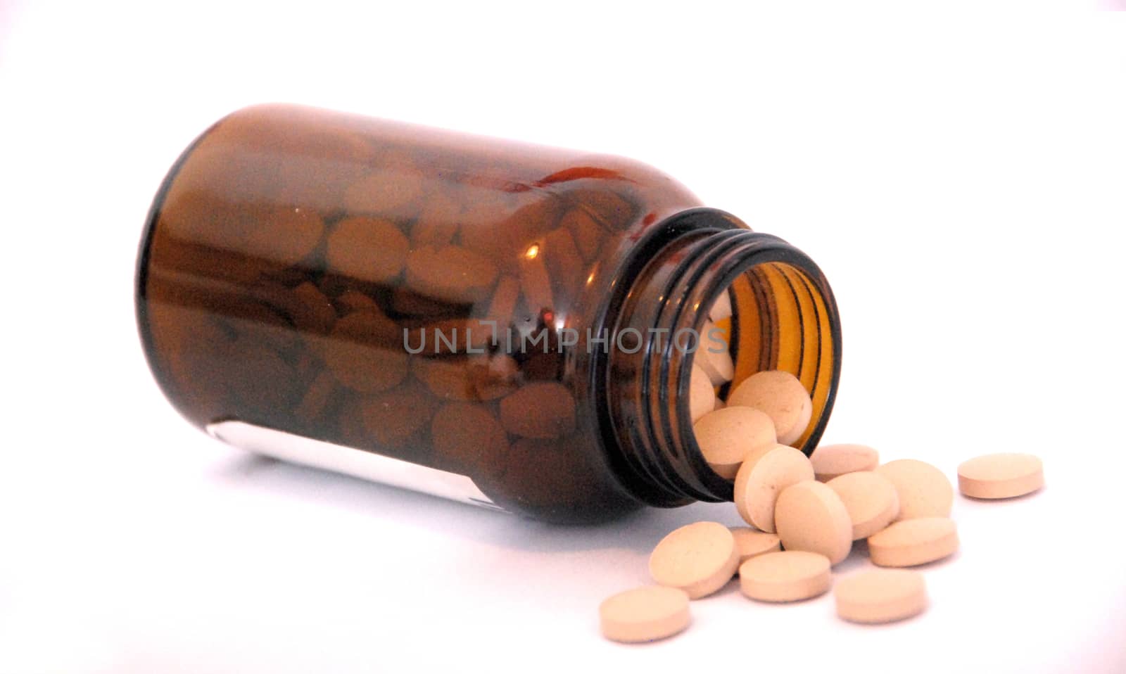 pills in a bottle on white background,