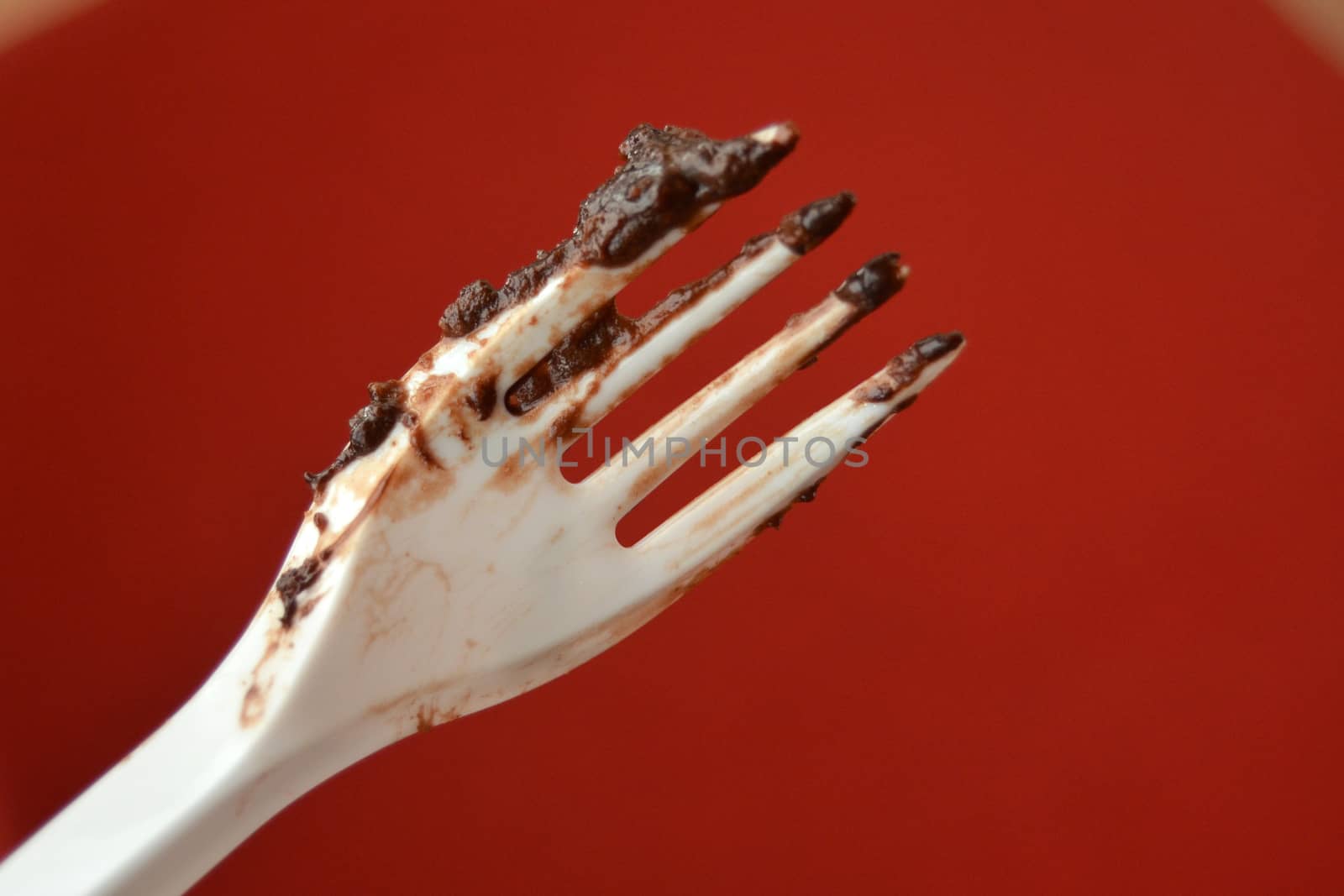 picture of a remains of Dark chocolate cake on a disposable fork