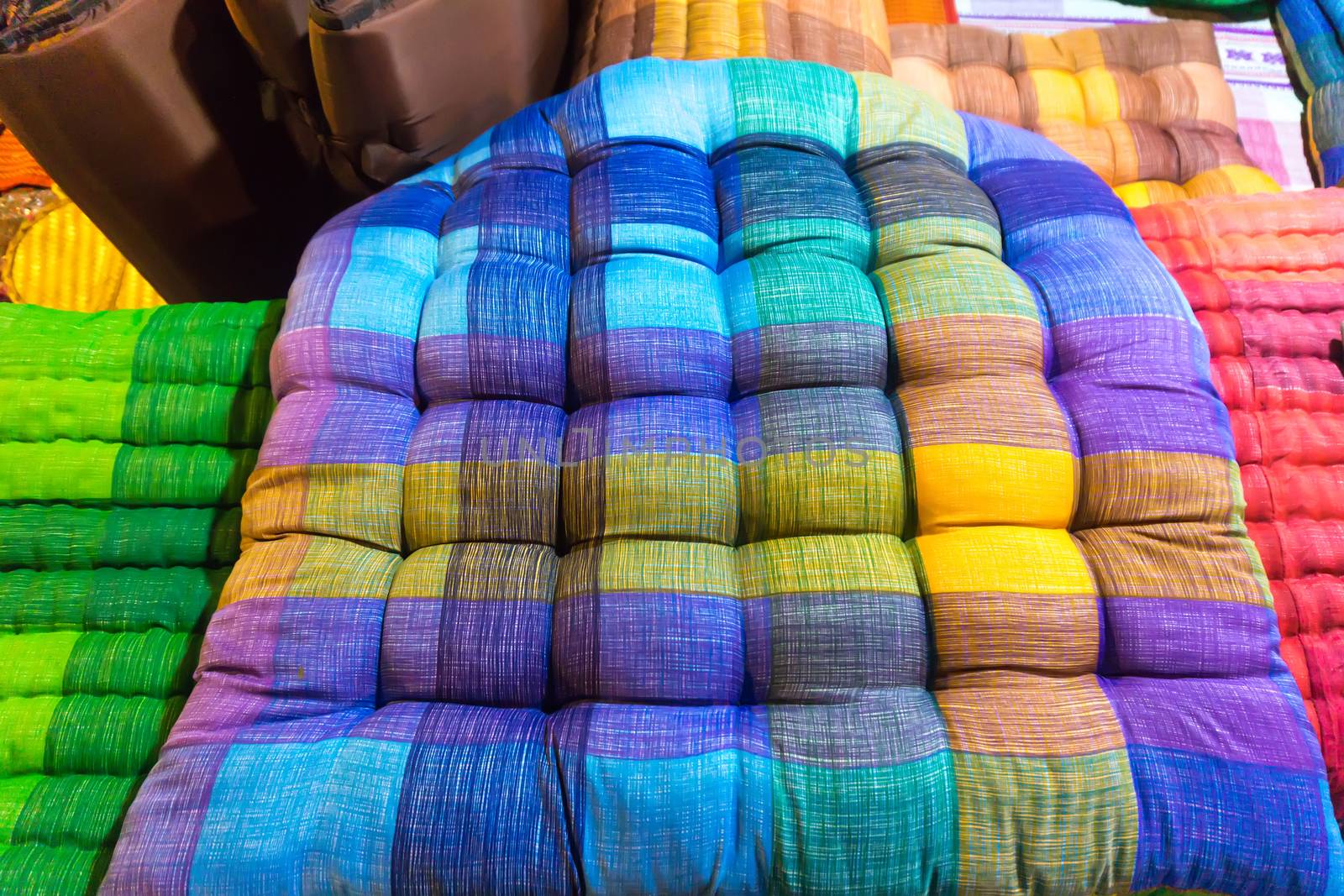 Colorful fabrics sit pillow at street market in thailand.