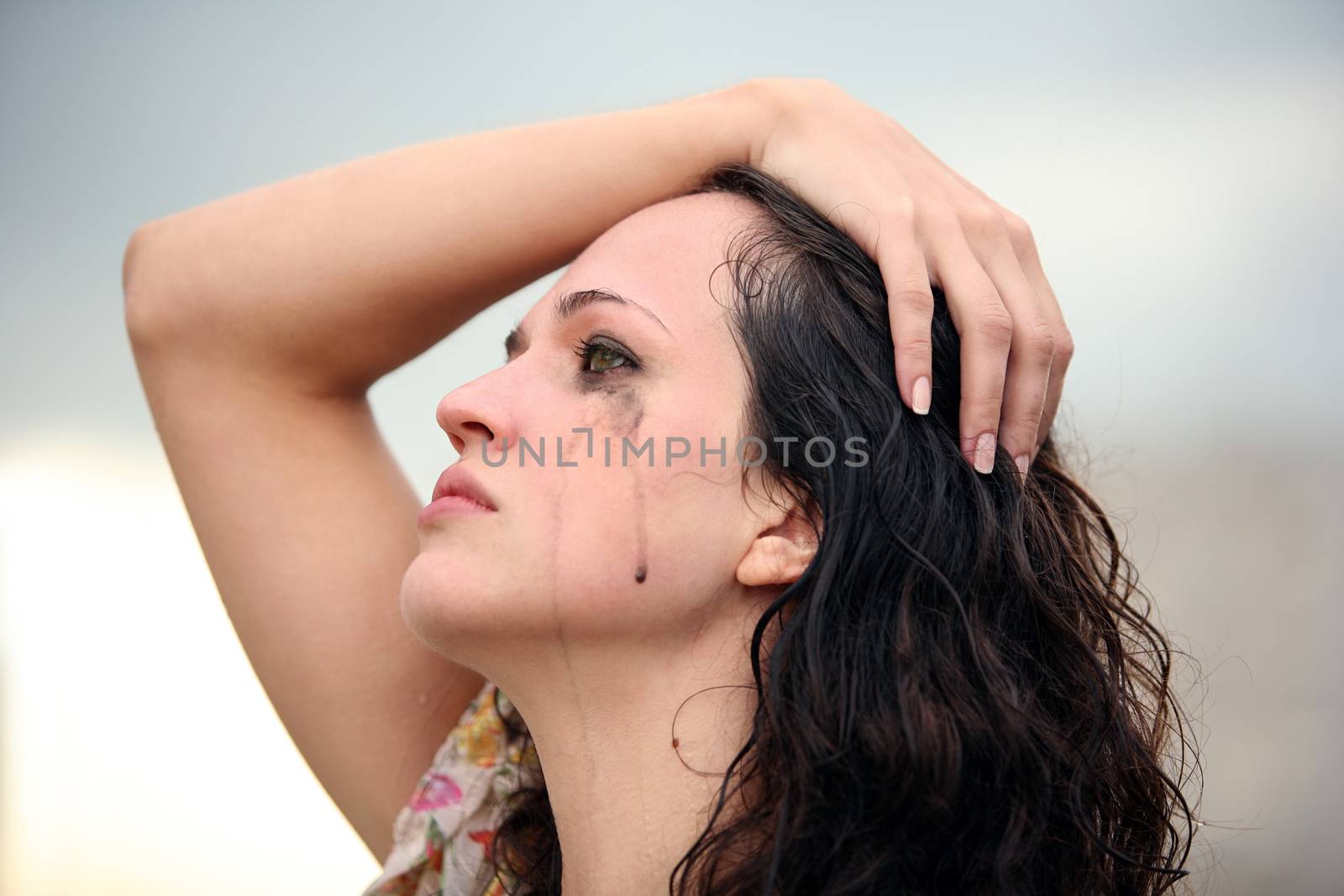 Portrait of a young crying brunette