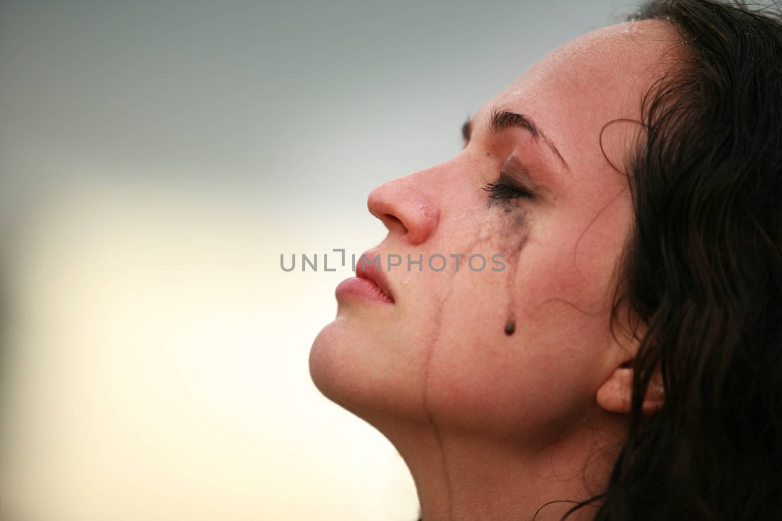 Portrait of a young crying brunette