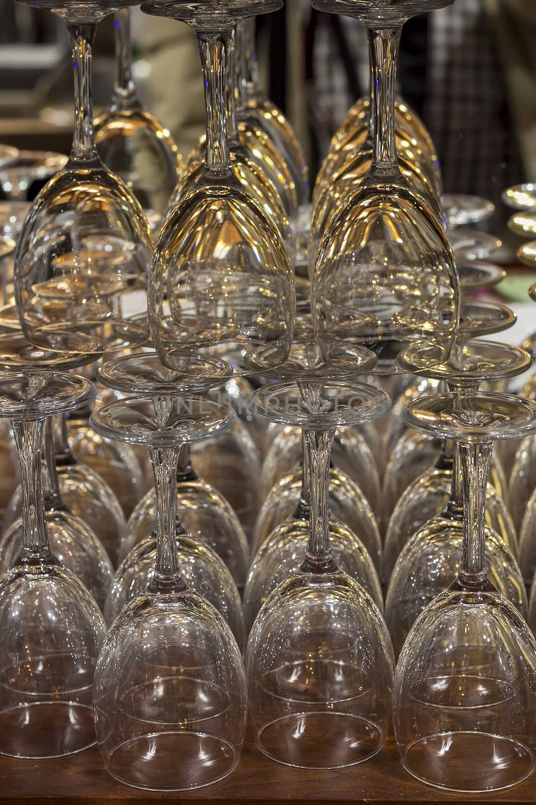 Empty glasses for wine sorted on a table in bar by EdVal