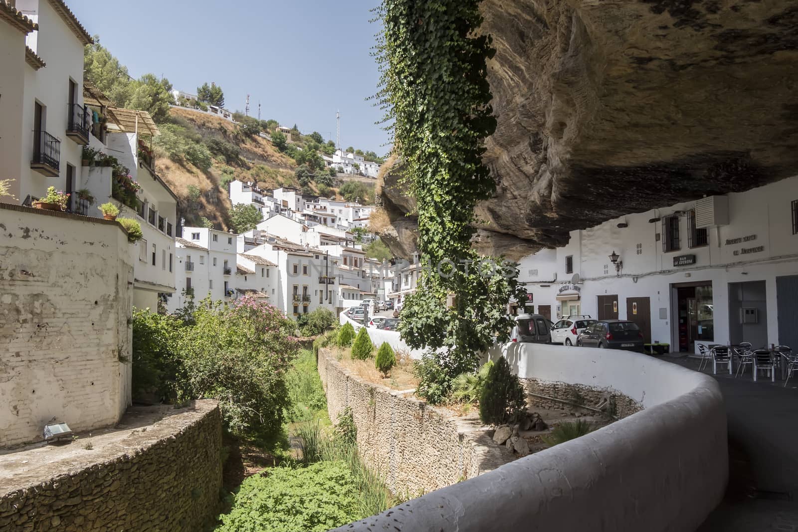 Setenil de las Bodegas, Cadiz, Spain. Street with dwellings built into rock overhangs above Rio Trejo. 