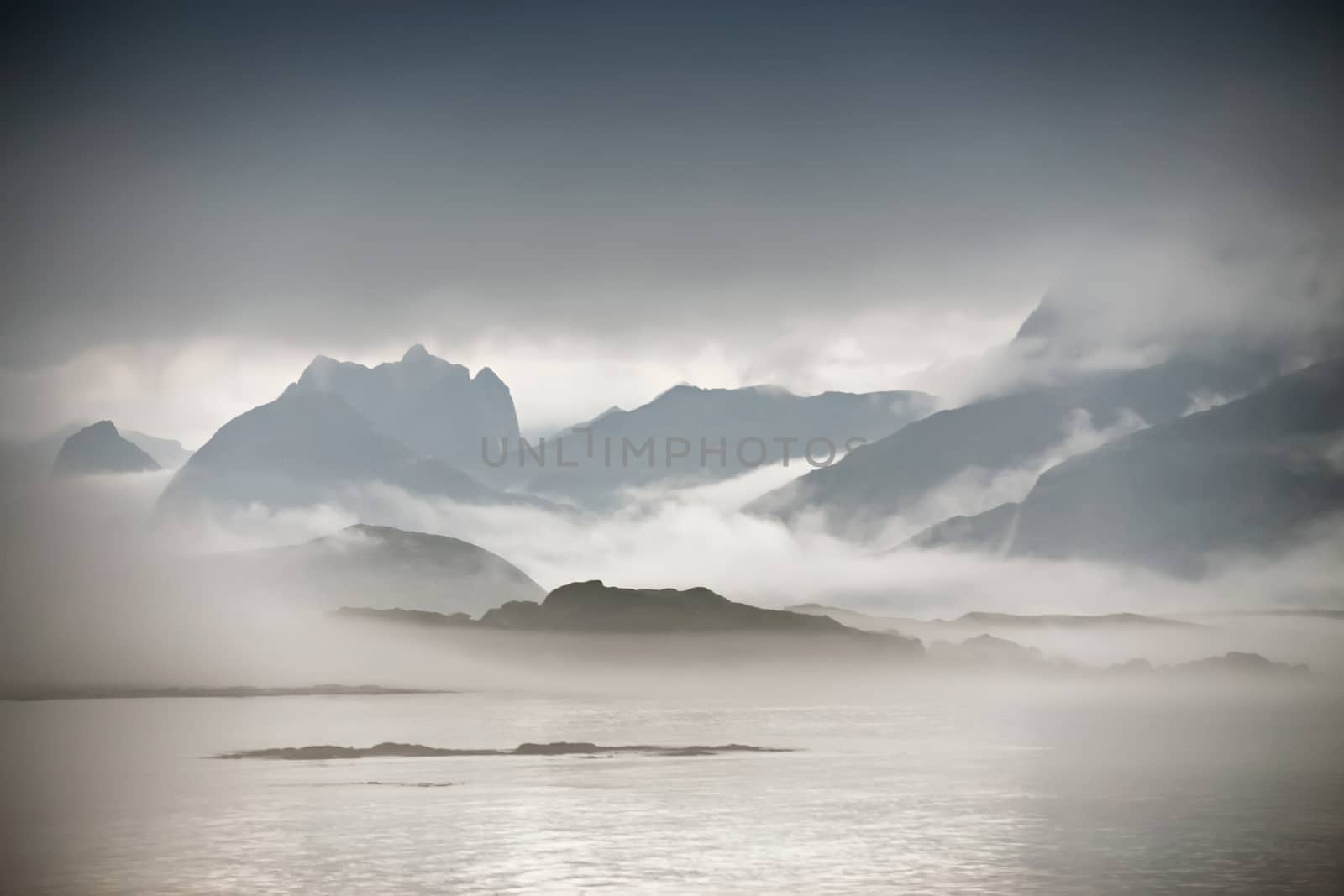 Coast of  Norway sea in clouds of fog. Cloudy Nordic day on Lofoten islands