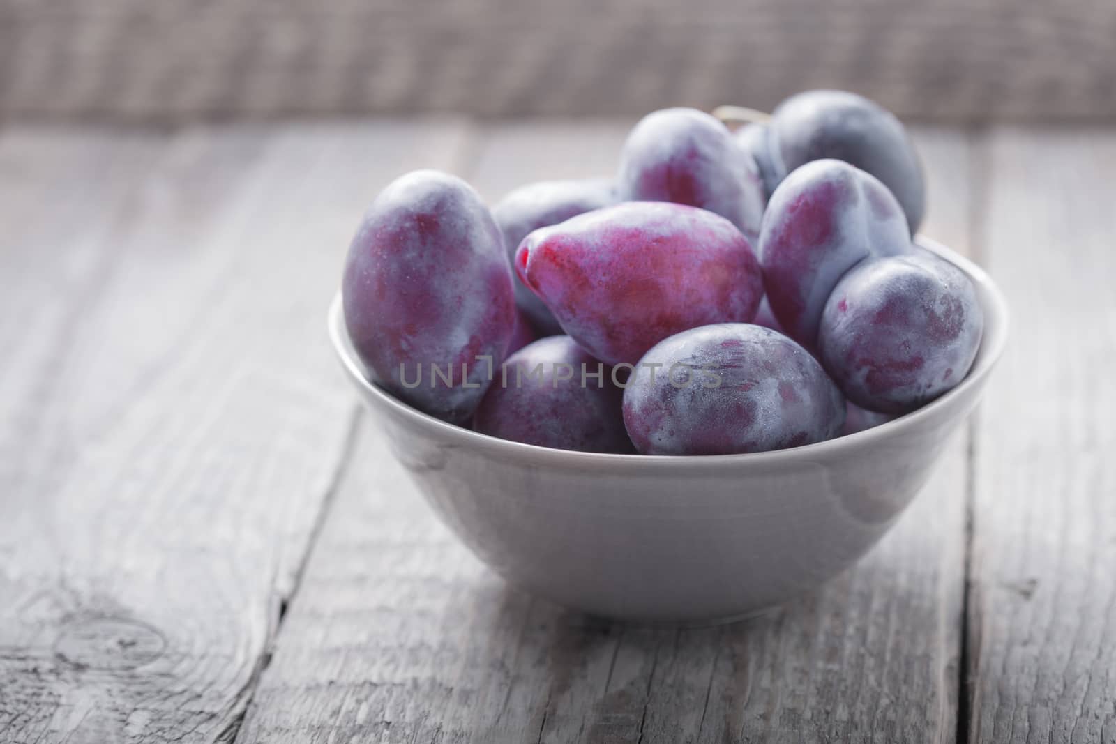 Bunch of Plums on a wooden table.