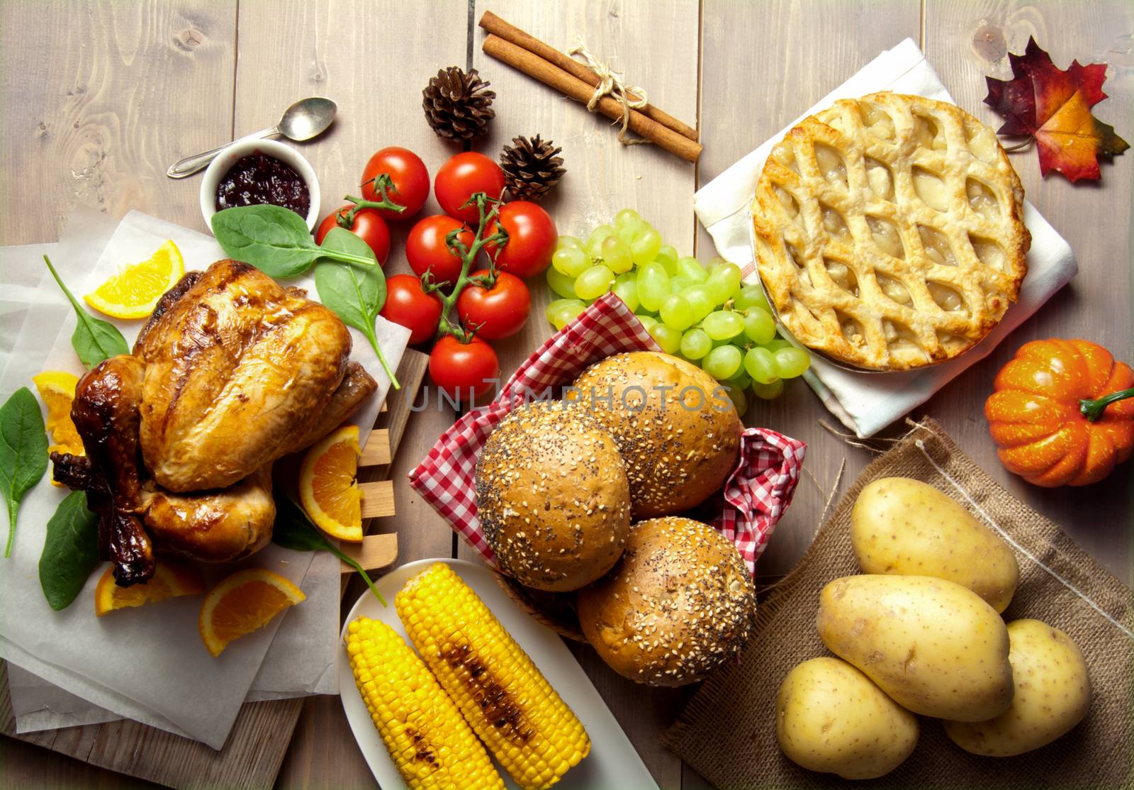 Thanksgiving savory and sweet food selection on top of a wooden background 