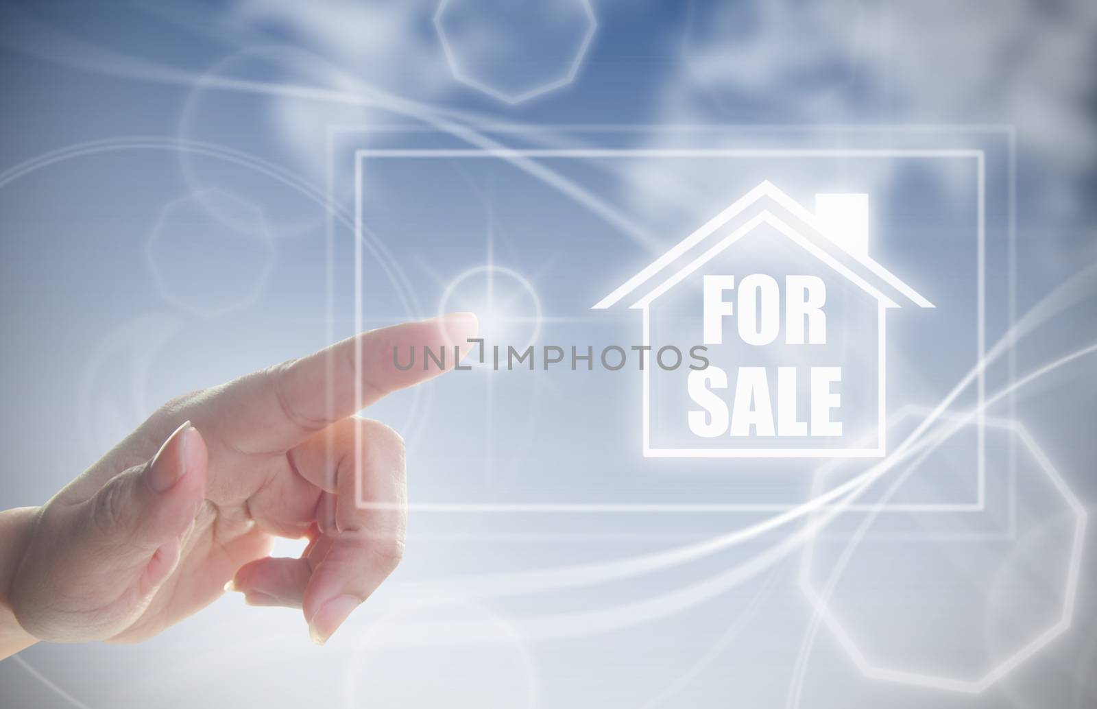 Hand clicking on house for sale by unikpix