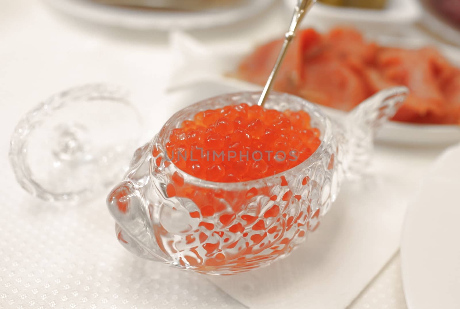red caviar in a crystal bowl with salmon closeup