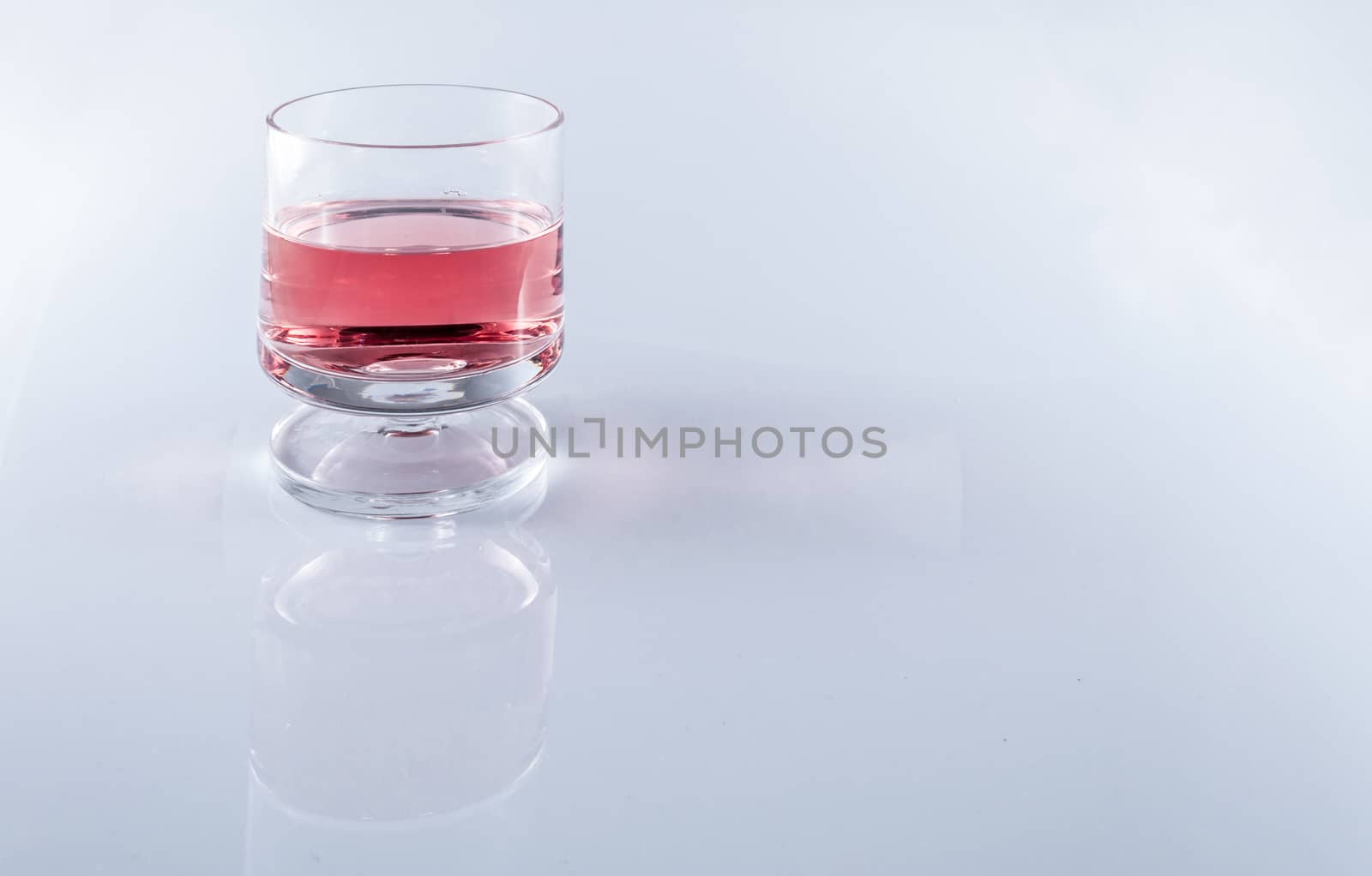 Isolated rosè wine in stemmed glasses on white background with copy space