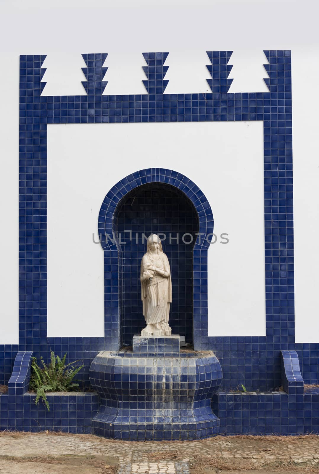 blue and white catholic monument with maria sculpture in moura alentejo Portugal