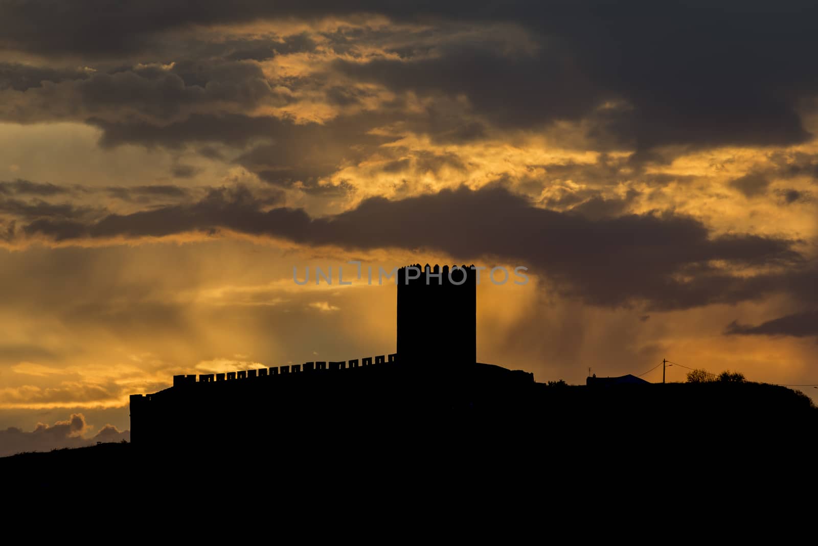 sunrays from the clouds over the catle of portel in portugal