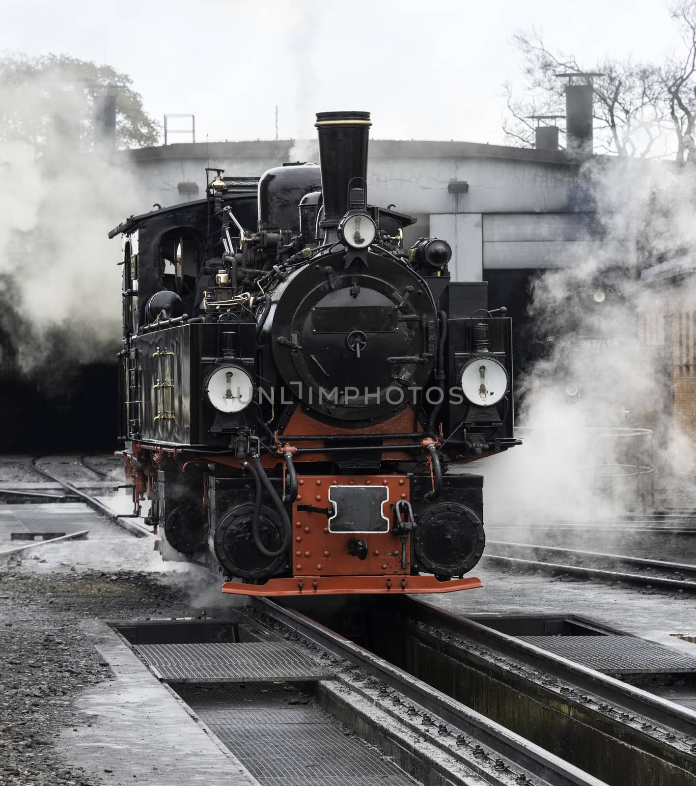 old black steam locomotive in germany by compuinfoto