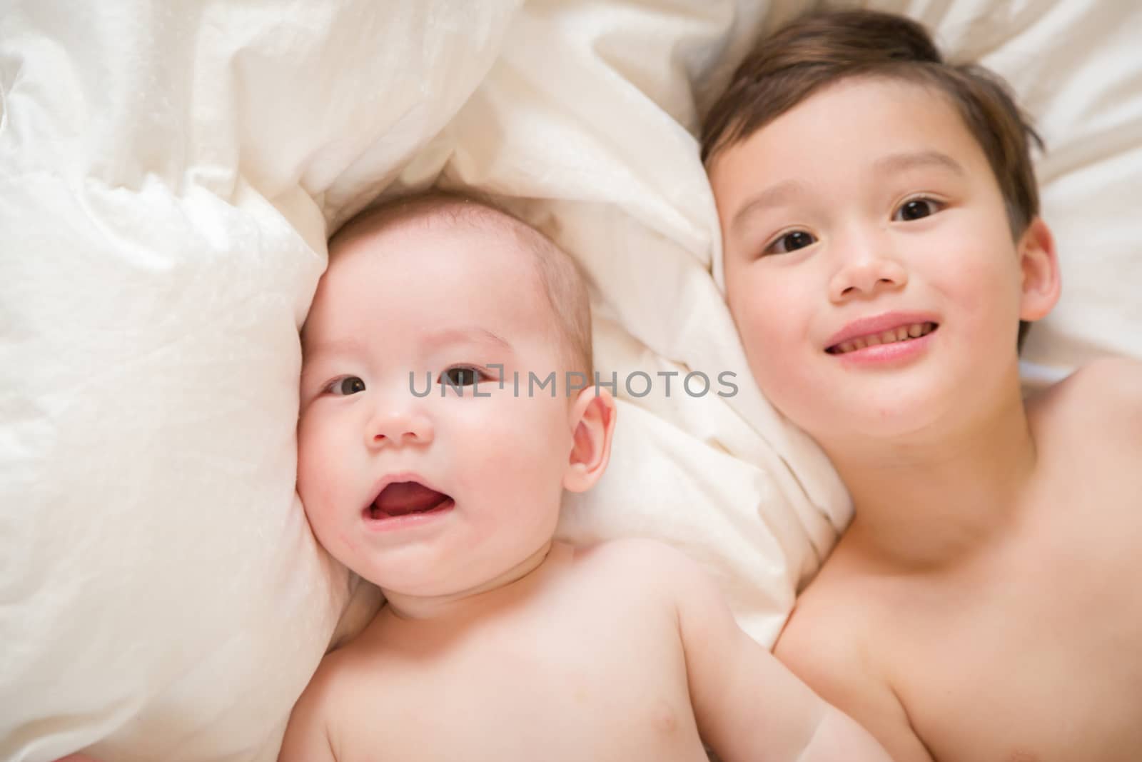 Young Mixed Race Chinese and Caucasian Baby Brothers Having Fun on Their Blanket.