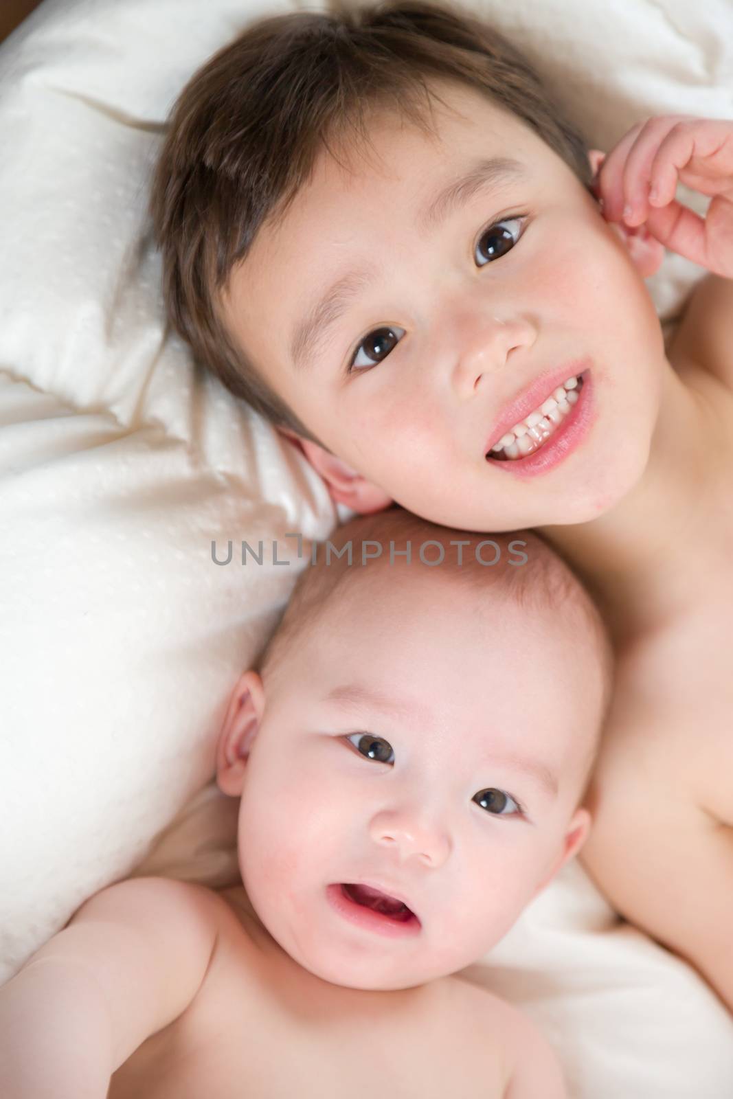 Young Mixed Race Chinese and Caucasian Baby Brothers Having Fun on Their Blanket.