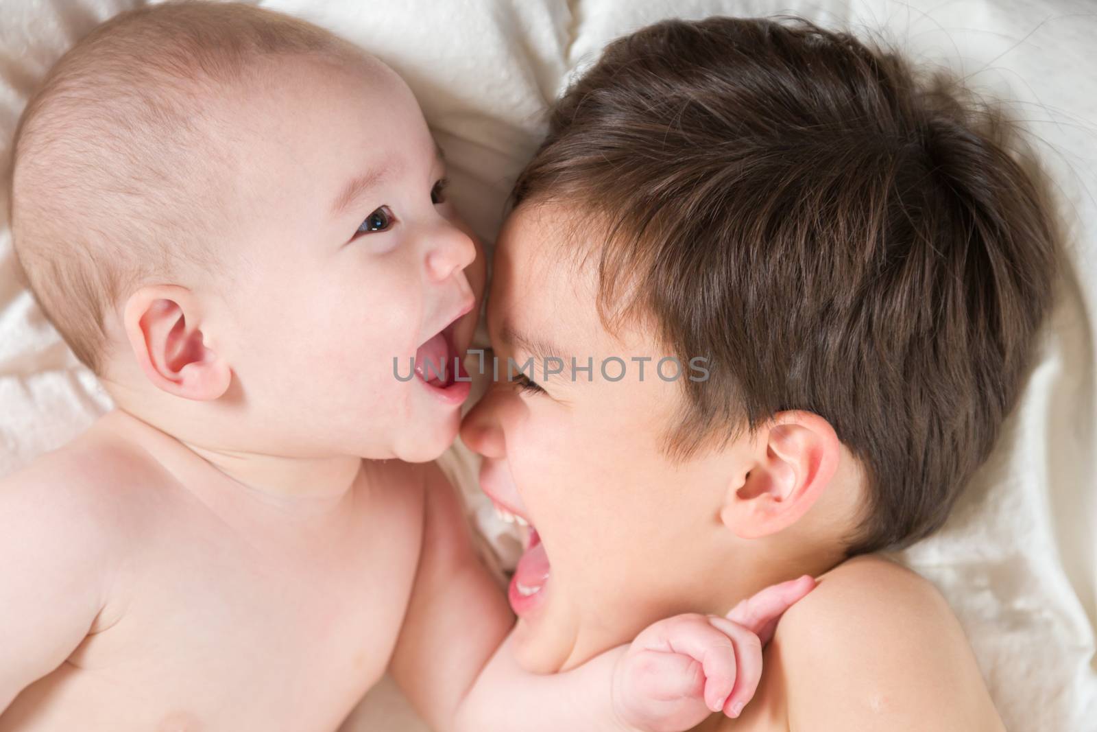 Young Mixed Race Chinese and Caucasian Baby Brothers Having Fun on Their Blanket.