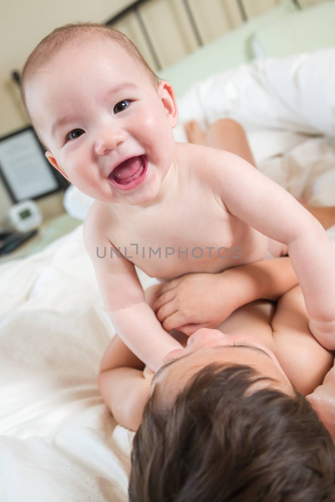 Young Mixed Race Chinese and Caucasian Baby Brothers Having Fun on Their Blanket.