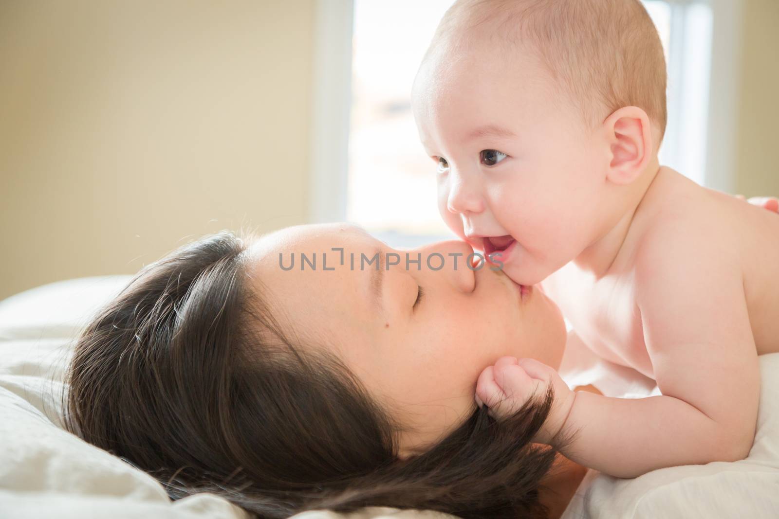 Mixed Race Chinese and Caucasian Baby Boy Laying In Bed with His by Feverpitched