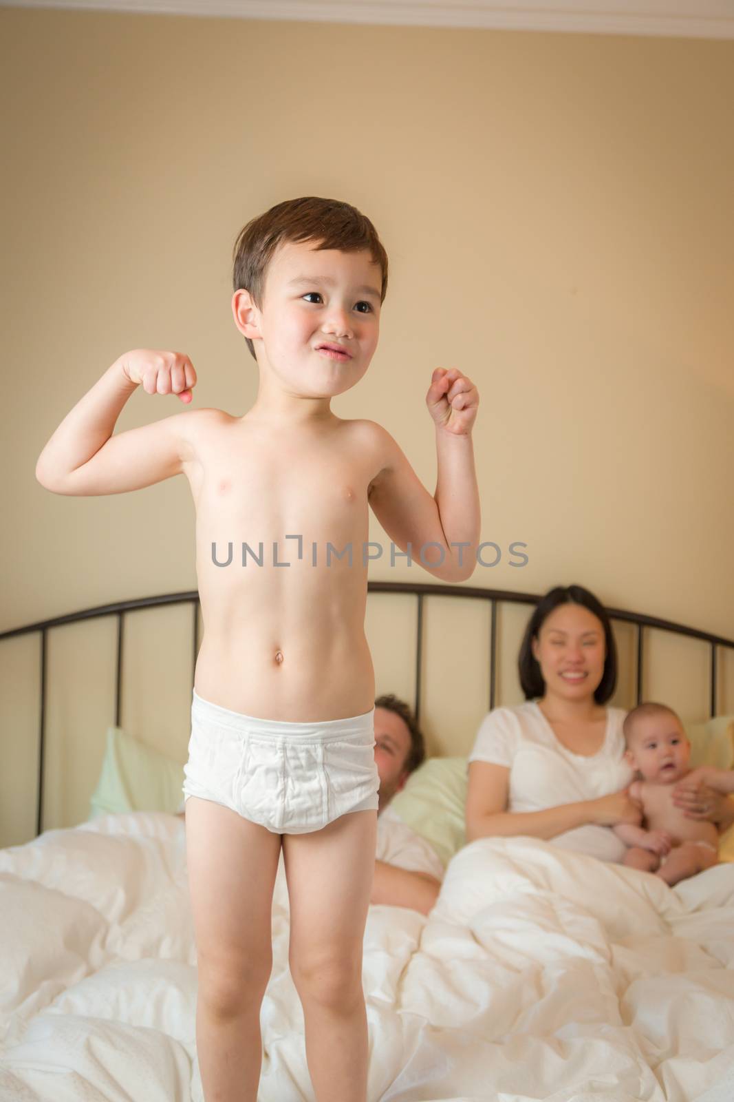 Mixed Race Chinese and Caucasian Boy Jumping In Bed with His Fam by Feverpitched