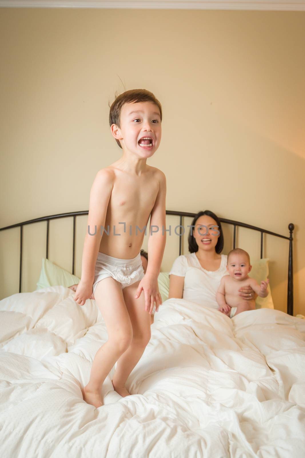 Mixed Race Chinese and Caucasian Boy Jumping In Bed with His Fam by Feverpitched