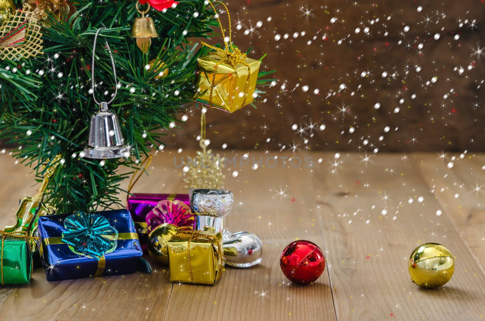 Christmas background with decorations and gift boxes on wooden board