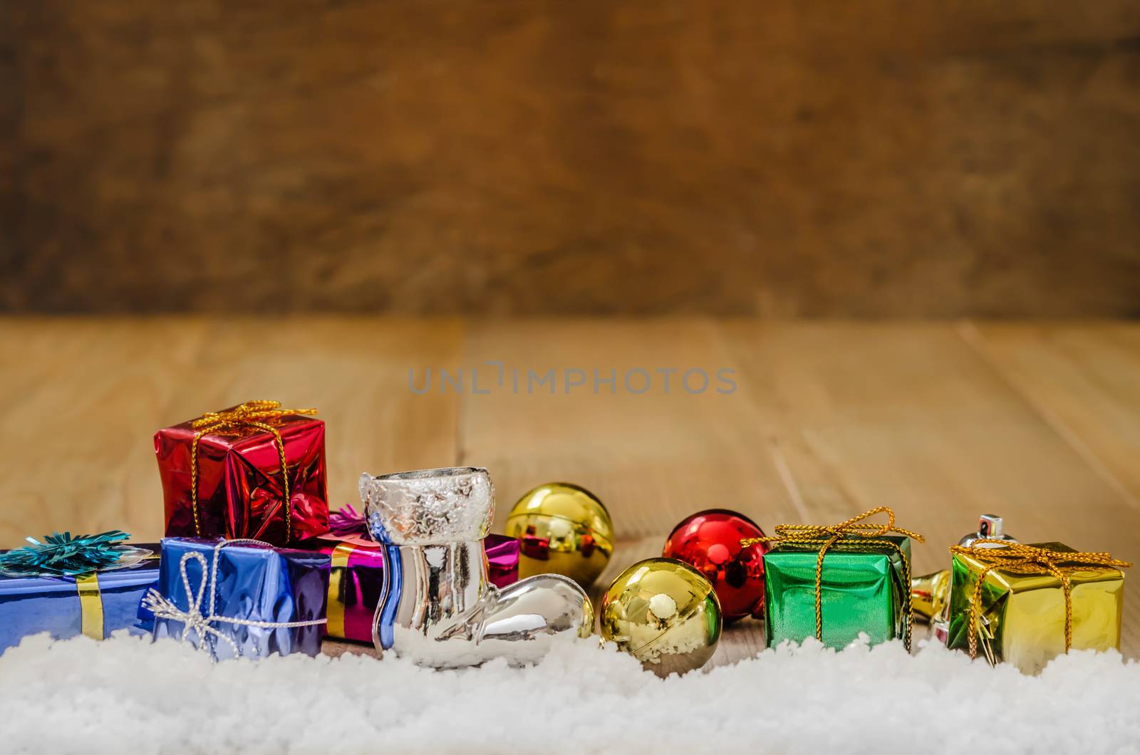 Christmas background with decorations and gift boxes on wooden board