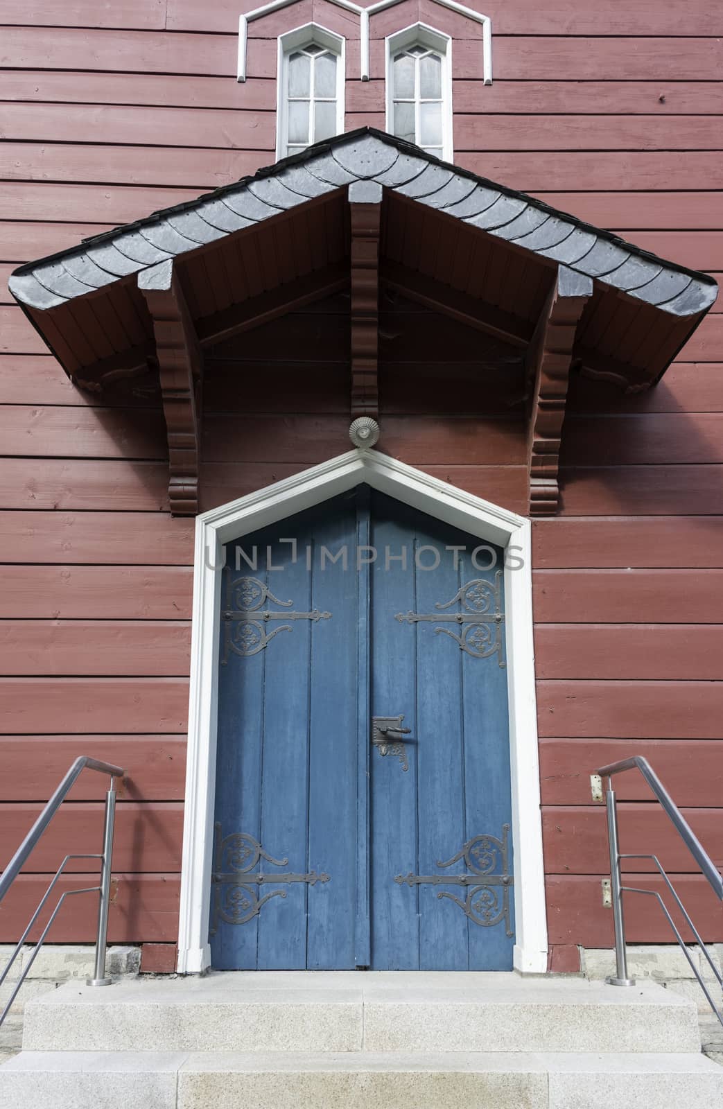 old church entrance with blue door in red wooden building