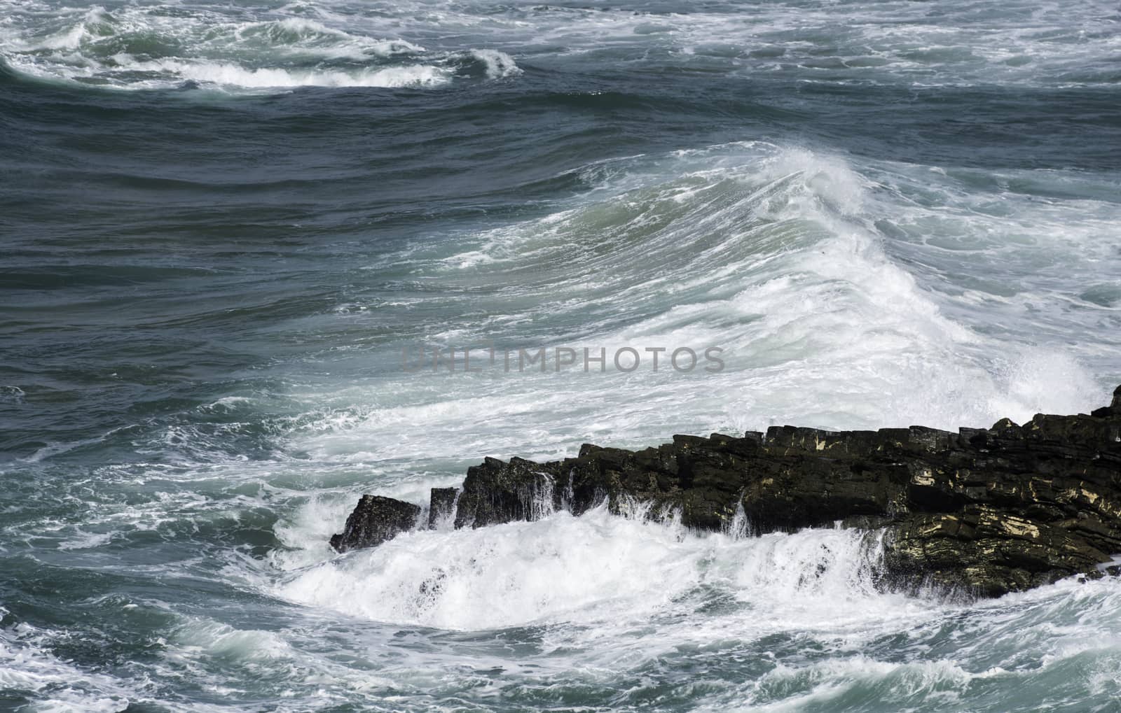 ble waves and white water with rocks in the ocean sea