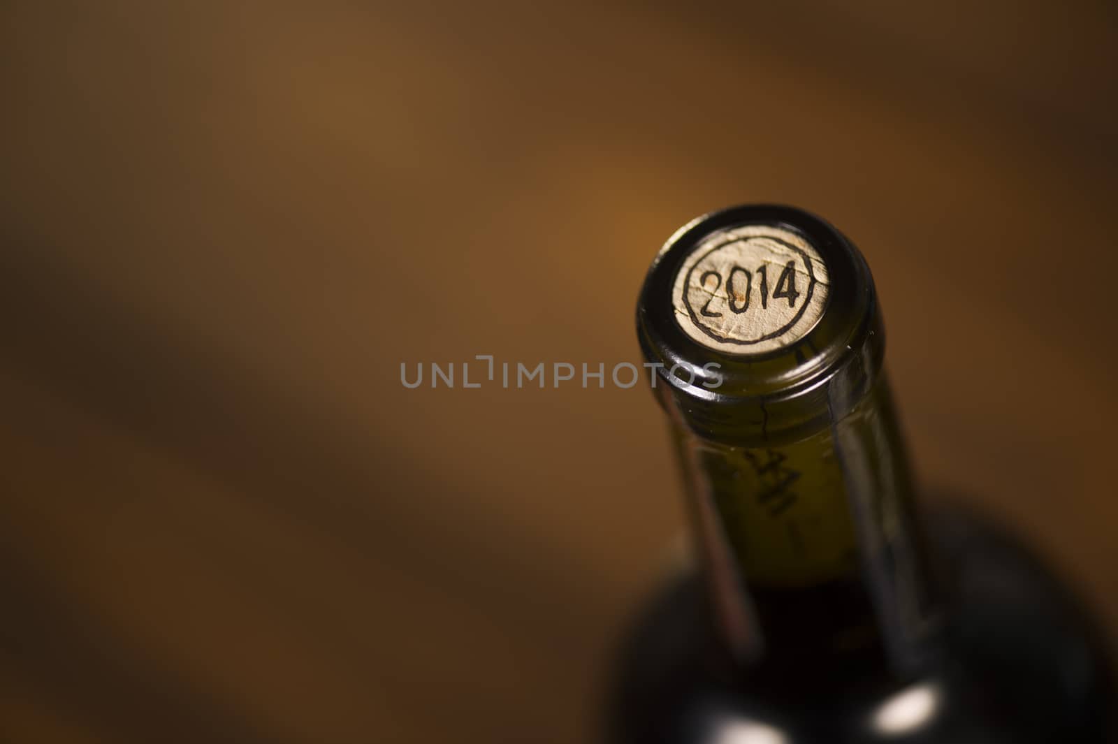 Close-up of closed wine bottles lying on blurry background, winery