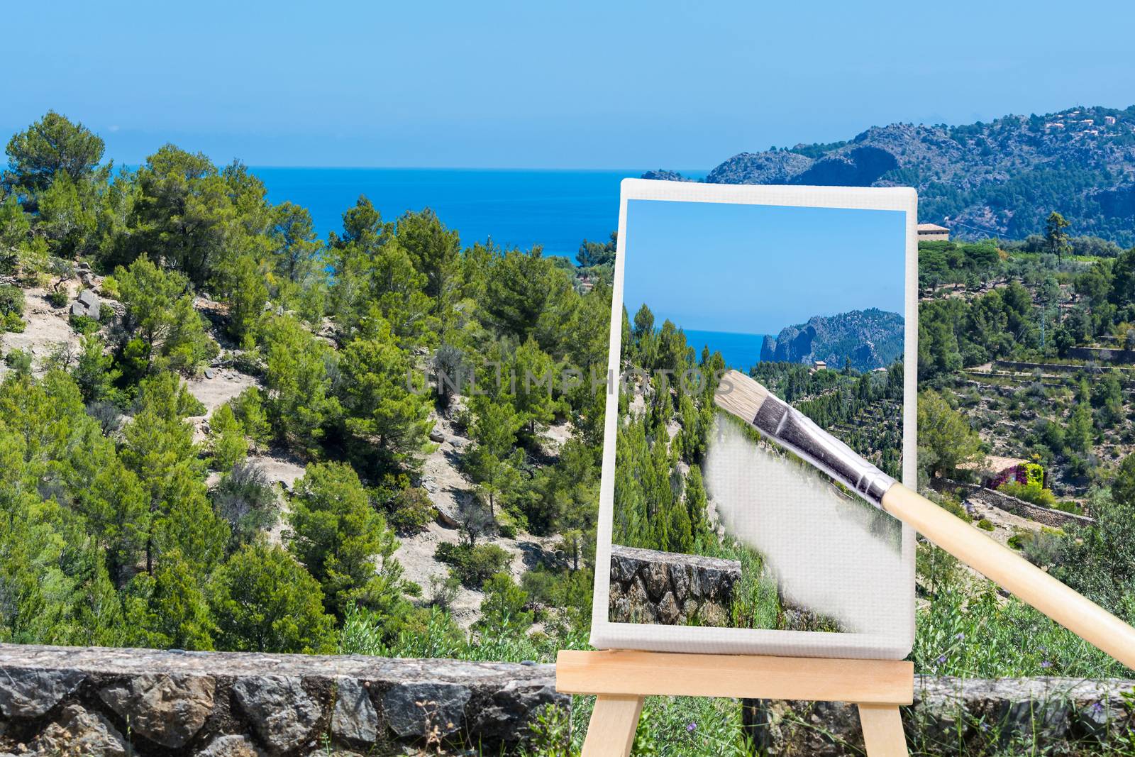 Painted canvas stands on an easel. On the screen, a holiday landscape with ocean in the background.