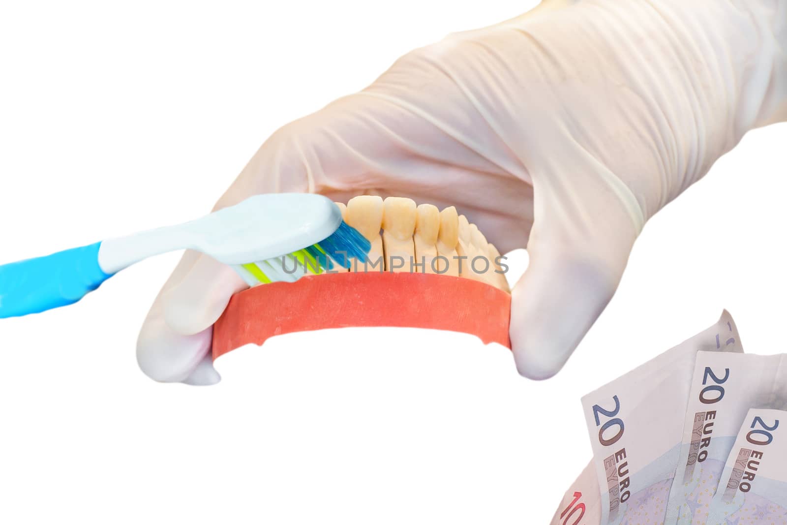 Dentures, toothbrush and money on white background by JFsPic