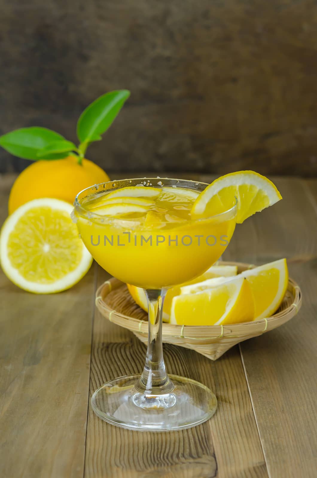 Fresh orange juice on wooden table over grunge background