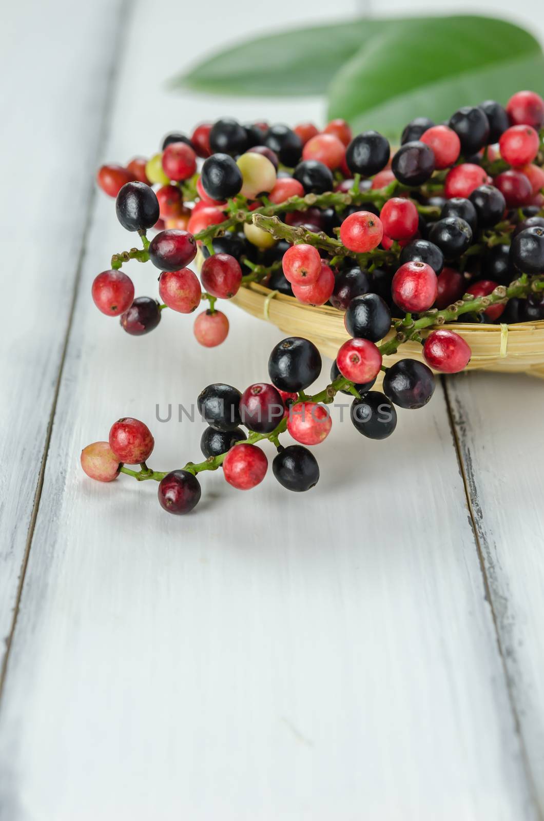 Thai Blueberry in bamboo basket over wooden background