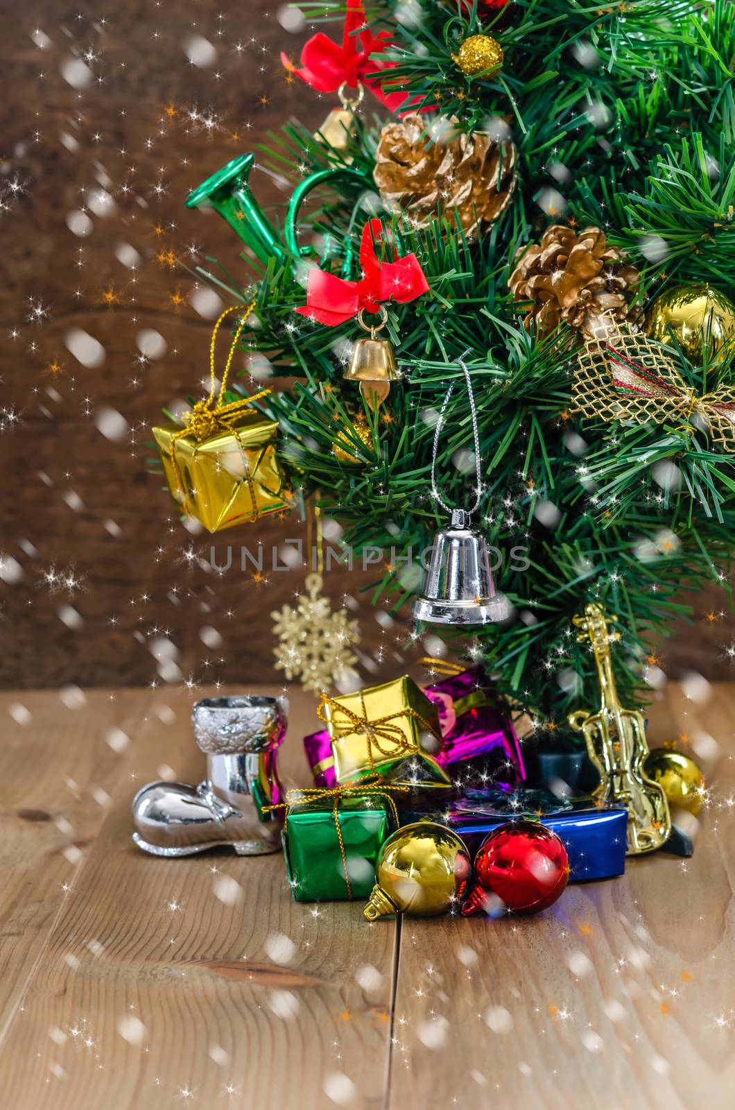 Christmas background with decorations and gift boxes on wooden board