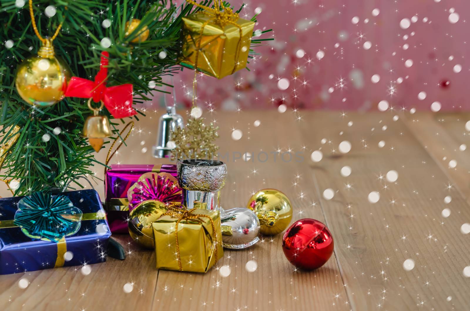 Christmas background with decorations and gift boxes on wooden board