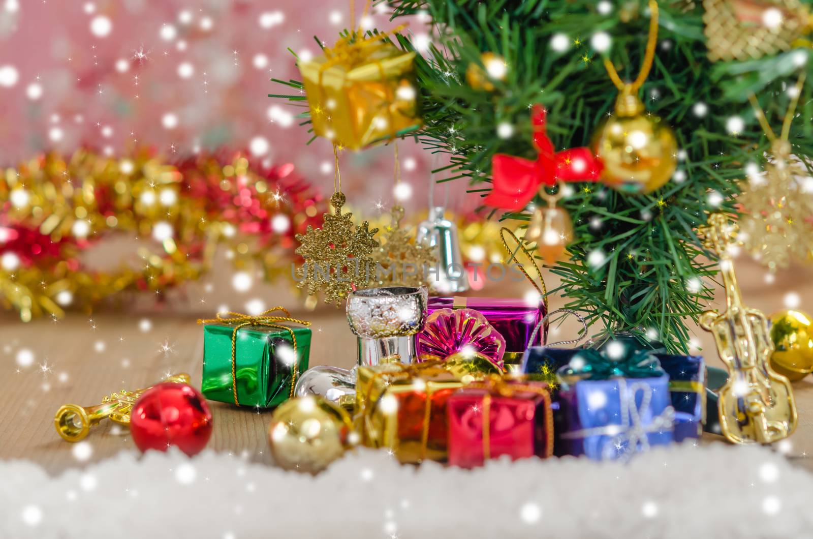 Christmas background with decorations and gift boxes on wooden board