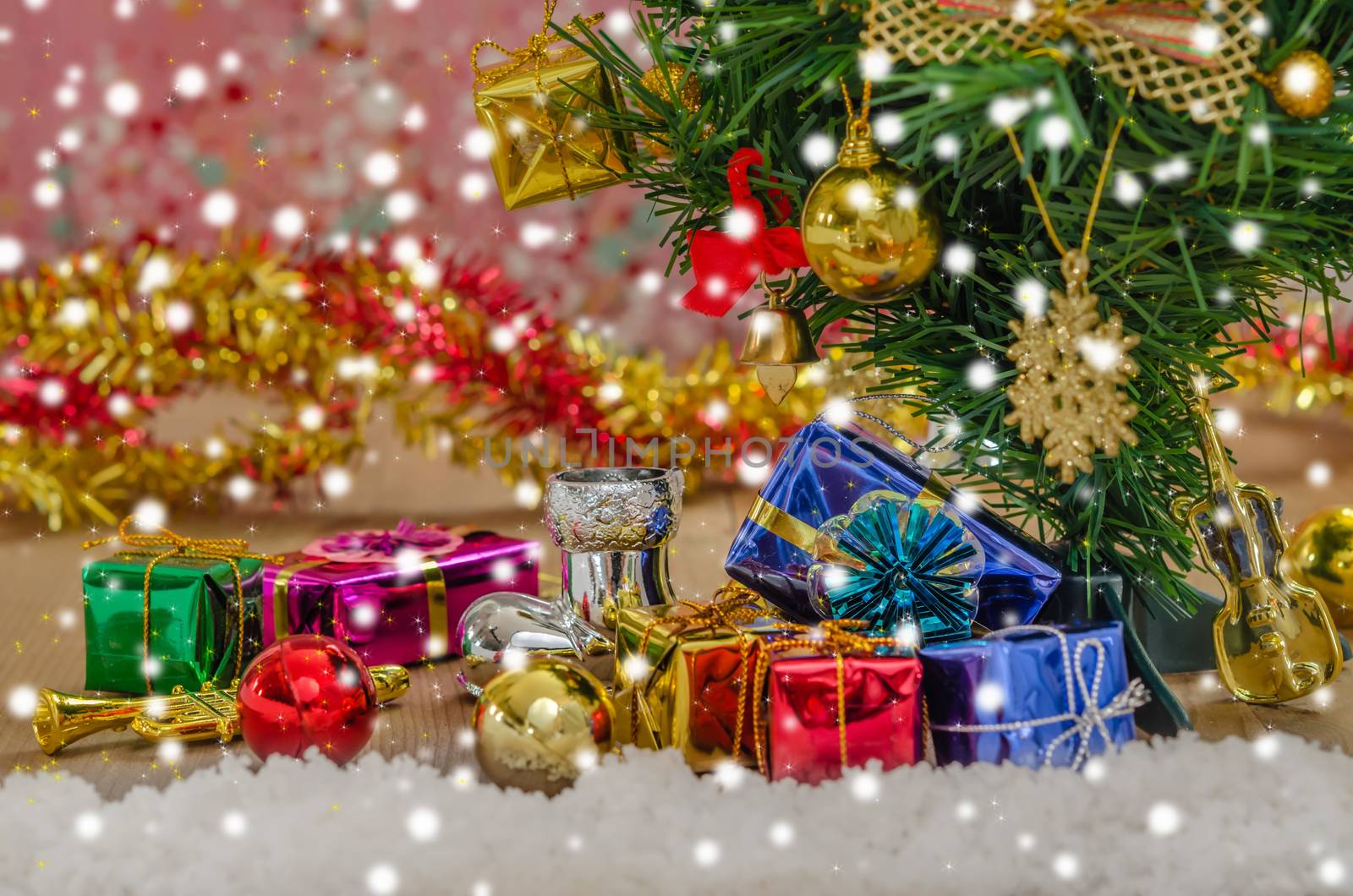 Christmas background with decorations and gift boxes on wooden board