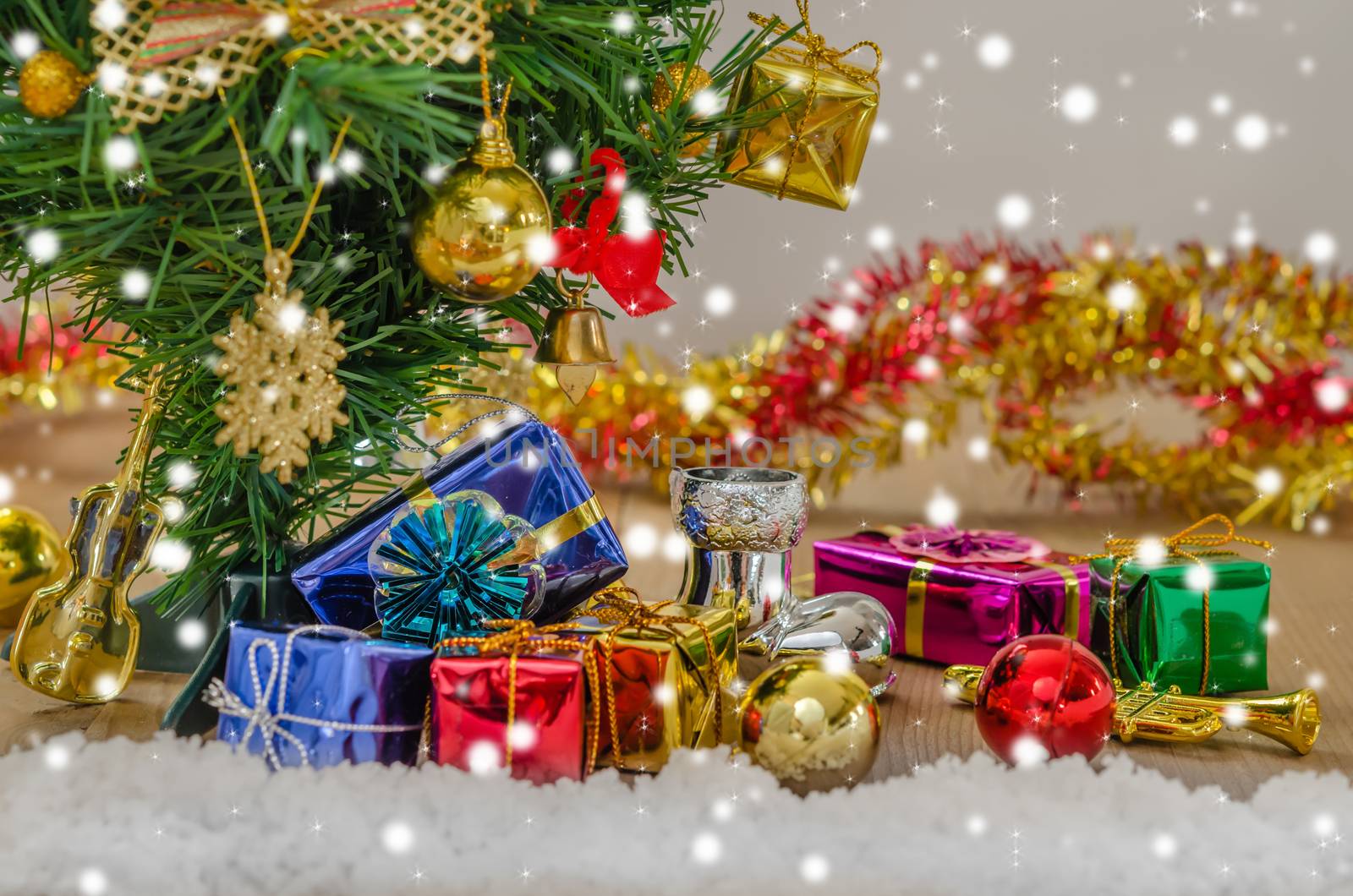 Christmas background with decorations and gift boxes on wooden board