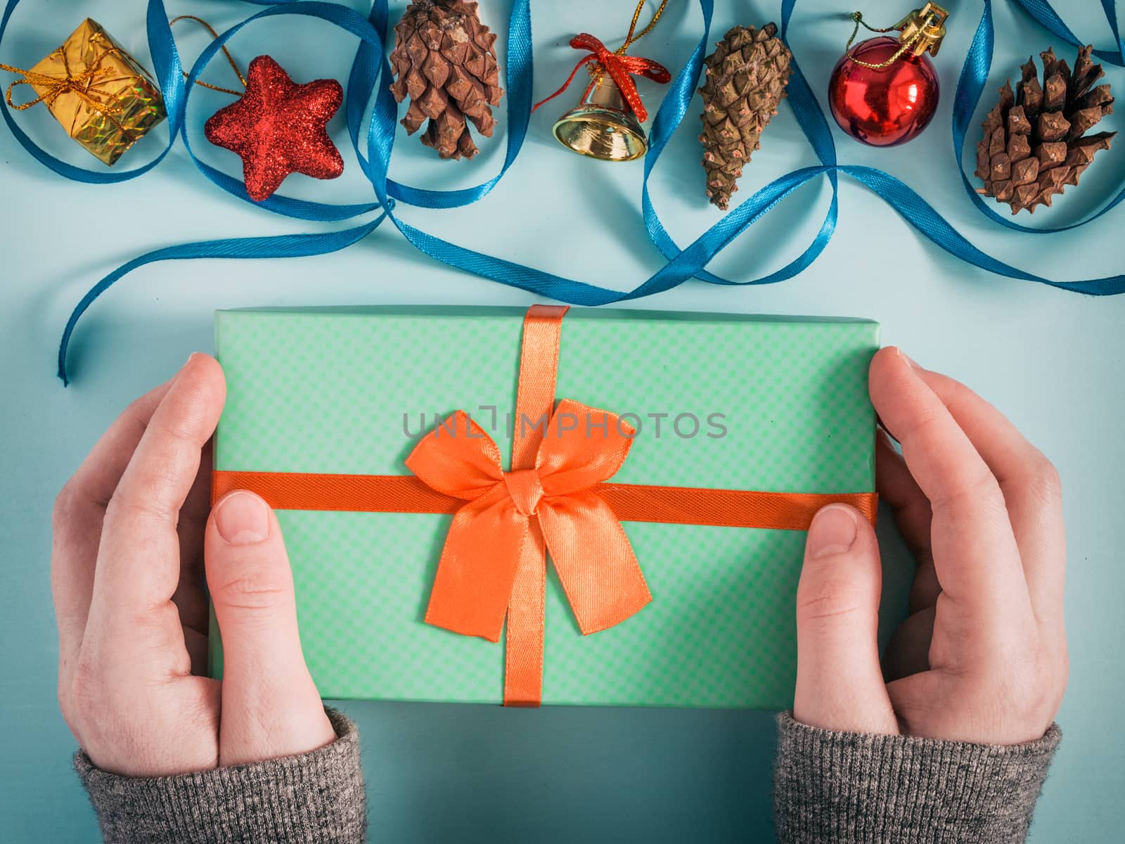 Female hands hold christmas gift box by fascinadora