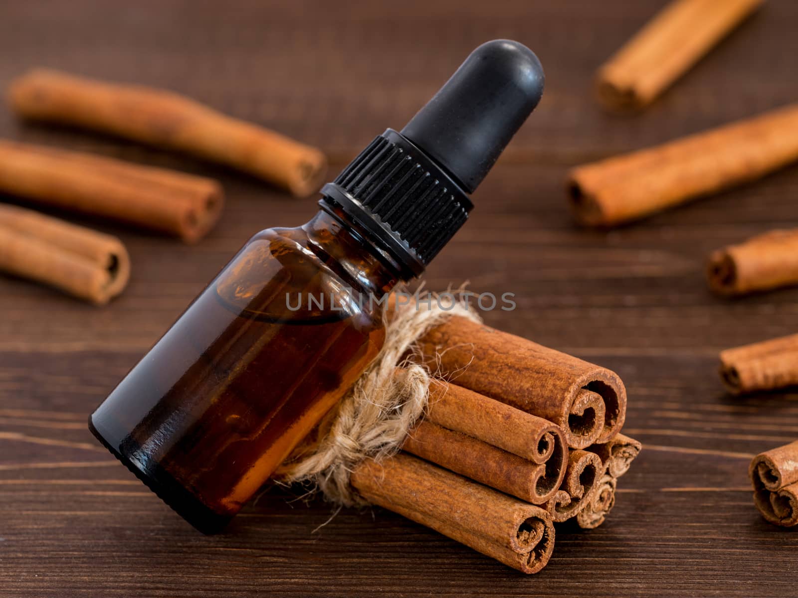 Cinnamon sticks and bottle with cinnamon essential oil
