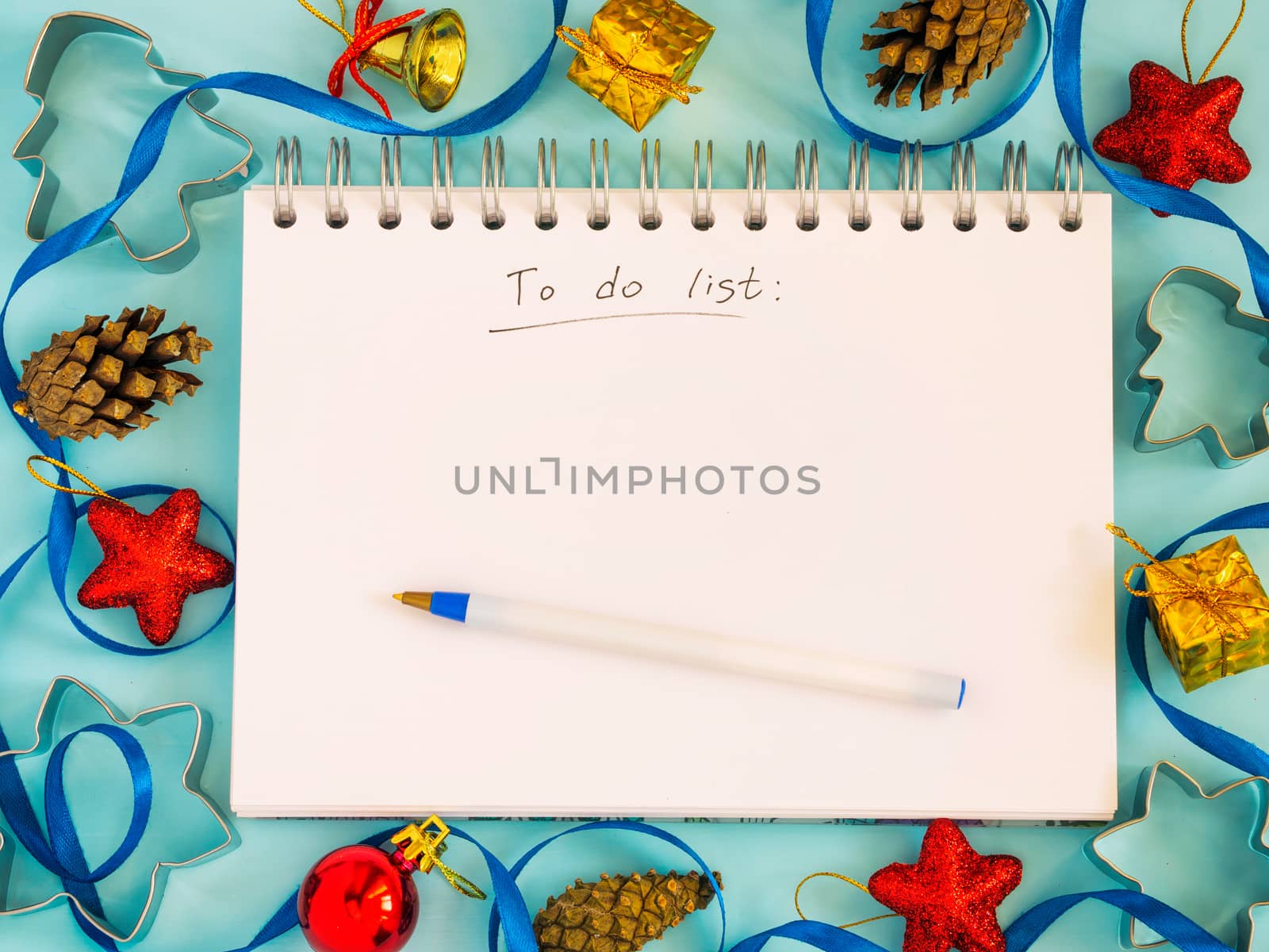 Christmas background with to-do list and decorations. Copy space. Top view or flat lay. Toned image