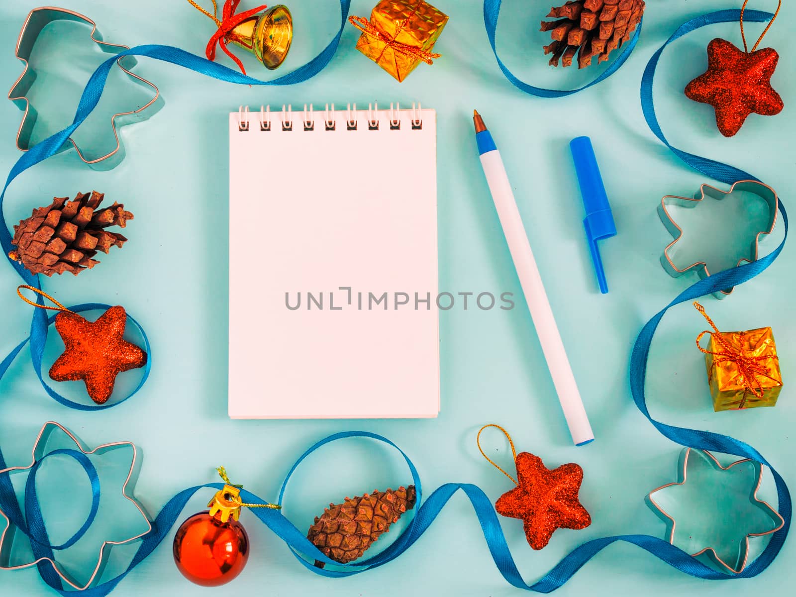Christmas background with blank notebook, decorations. Copy space. Top view or flat lay. Toned image