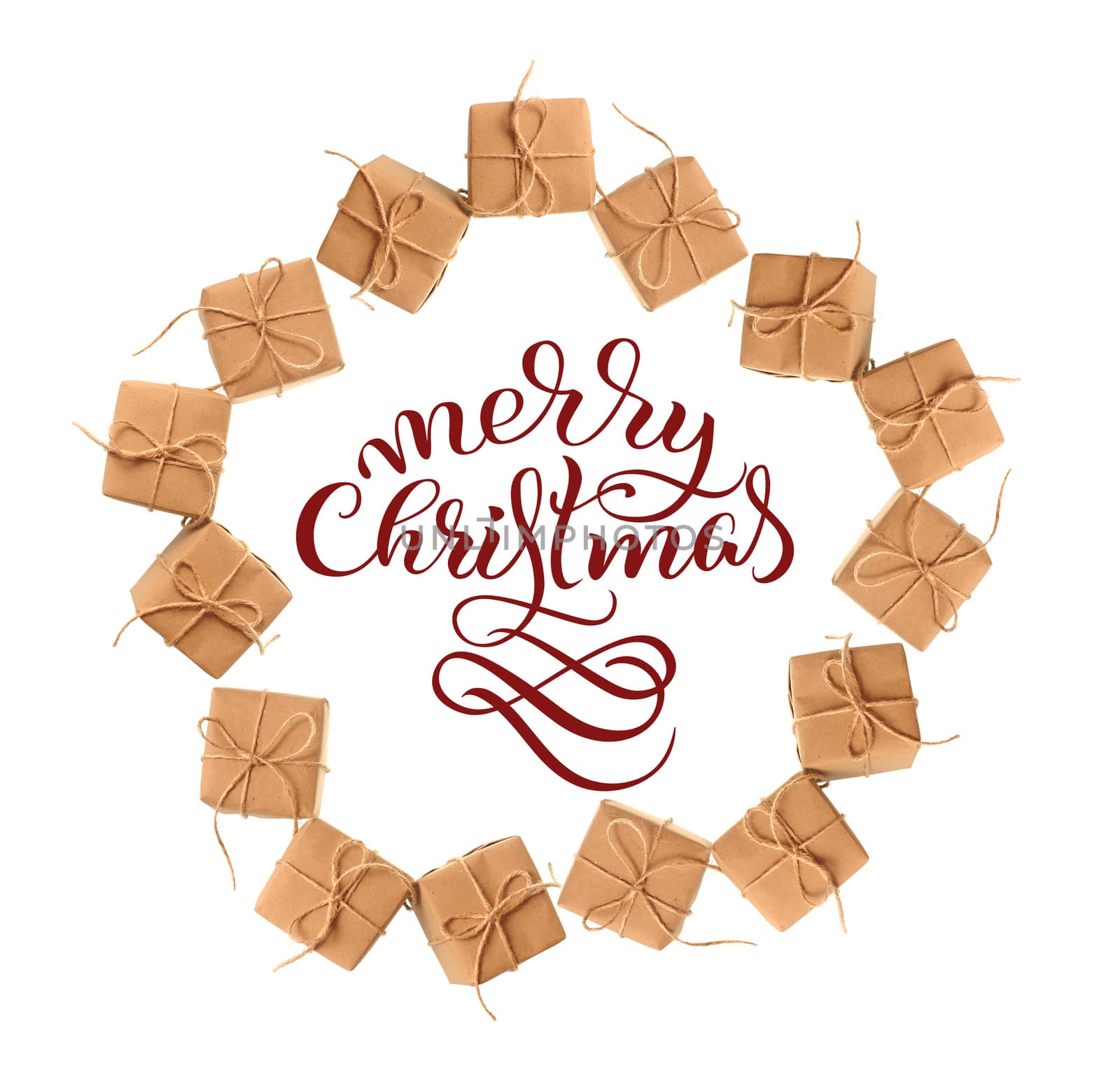gift boxes of kraft paper isolated on a white background and text Merry Christmas. Calligraphy lettering.
